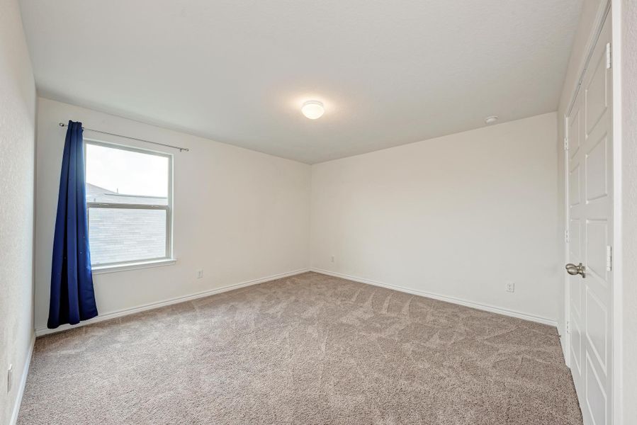 An inviting room offering a spacious, naturally lit retreat, perfect for unwinding.