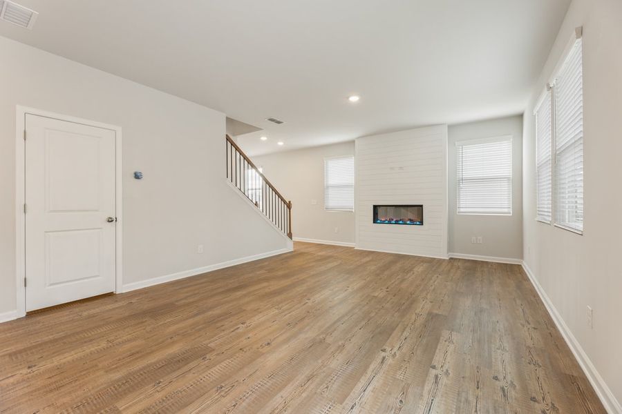 A room with a wood floor and white walls.