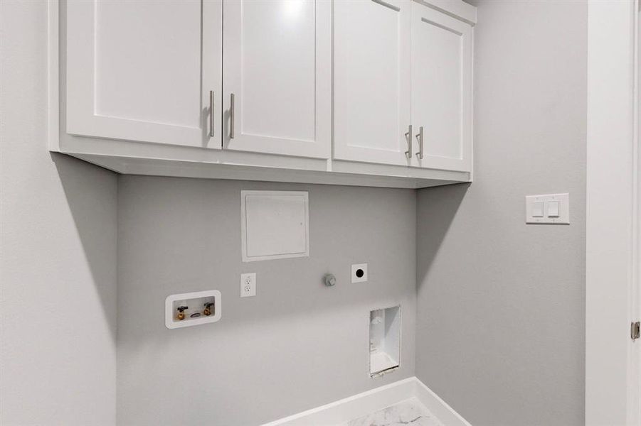 Laundry room featuring cabinets, hookup for a washing machine, and electric dryer hookup