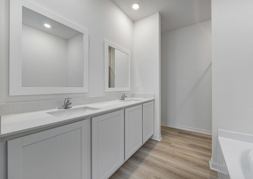 Dual sink vanity and framed mirrors in the master bathroom
