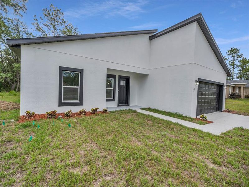 Front exterior of a new home in , Ocala, FL, highlighting curb appeal (Image 2).