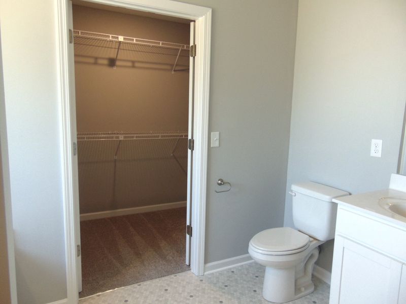 The primary bath includes a modern soaking tub for relaxation, and a shower. As well as two sinks, an elongated toilet, and your spacious closet.