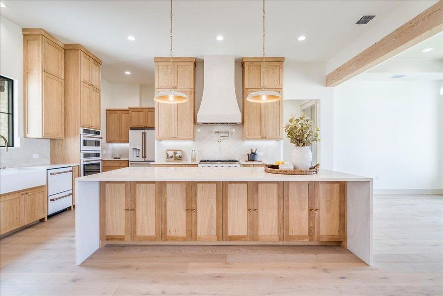 Culinary excellence awaits in this modern kitchen, featuring a spacious island and top-tier stainless steel appliances.