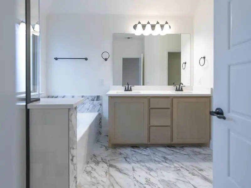 Bathroom featuring vanity and a tub