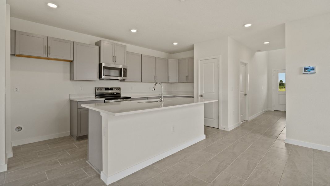 The Naples Kitchen with large Island Quick Move-In Home at Willowbrook North by DRB Homes in Winter Haven, FL The Naples Kitchen with large Island Quick Move-In Home at Willowbrook North by DRB Homes in Winter Haven, FL