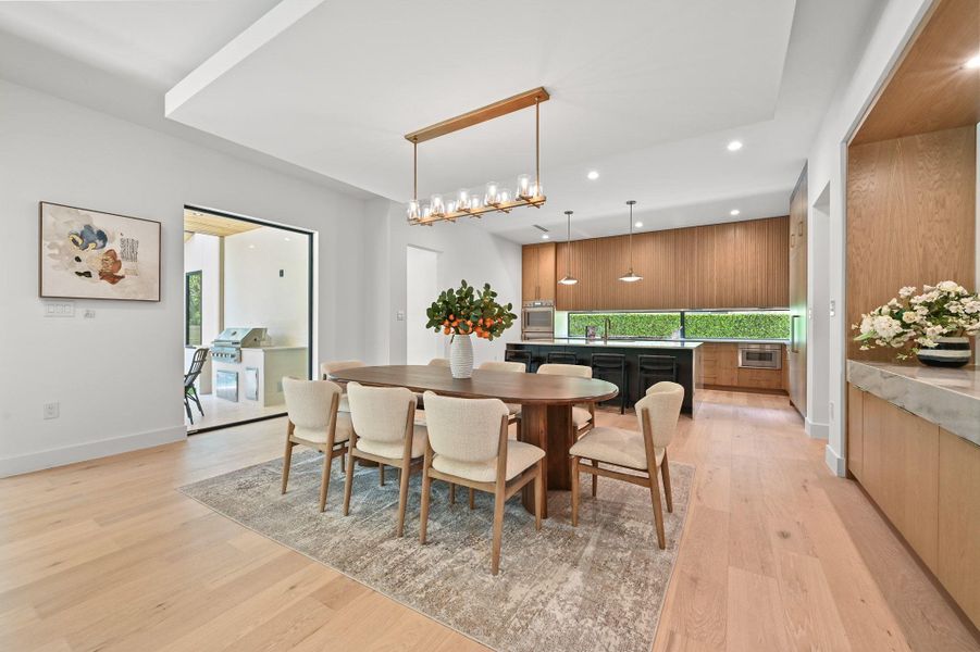 Dining area featuring light wood-style floors and recessed lighting