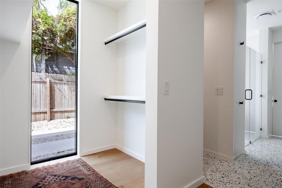 Walk in closet with light wood-type flooring