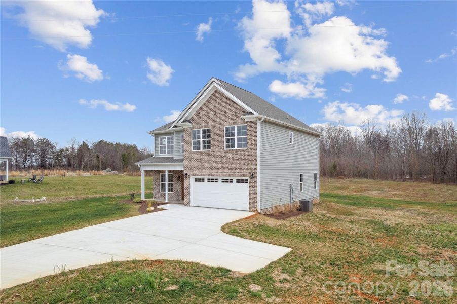 Front exterior of a new home in , Mocksville, NC, highlighting curb appeal (Image 13).