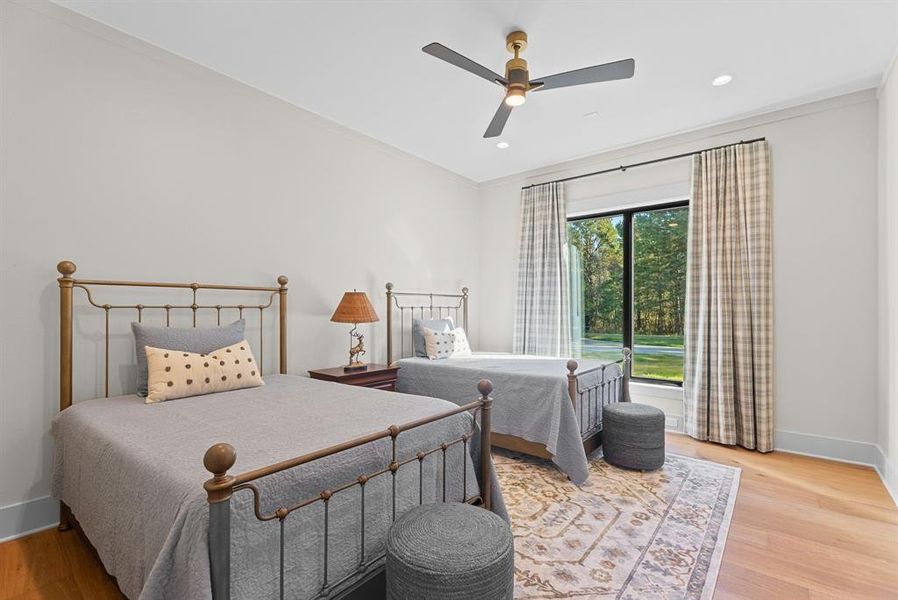 Bedroom featuring light wood-type flooring, a ceiling fan, ornamental molding, and recessed lighting