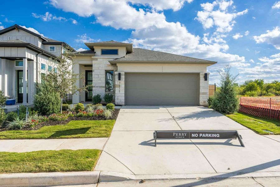 Prairie-style home with stone siding, driveway, an attached garage, and roof with shingles Prairie-style home with stone siding, driveway, an attached garage, and roof with shingles