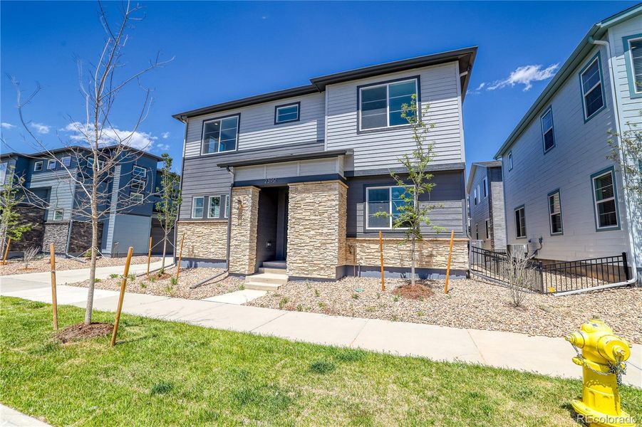 Front exterior of a new home in The Aurora Highlands Summit Collection, Aurora, CO, highlighting curb appeal (Image 2). Front exterior of a new home in The Aurora Highlands Summit Collection, Aurora, CO, highlighting curb appeal (Image 2).