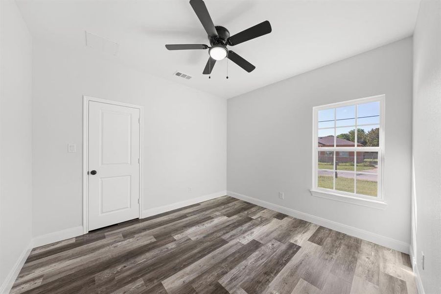 Unfurnished room featuring wood finished floors and ceiling fan Unfurnished room featuring wood finished floors and ceiling fan