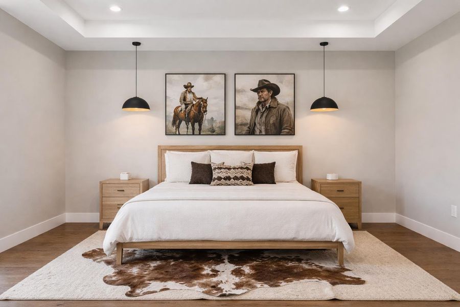Bedroom with a raised ceiling, wood finished floors, and recessed lighting