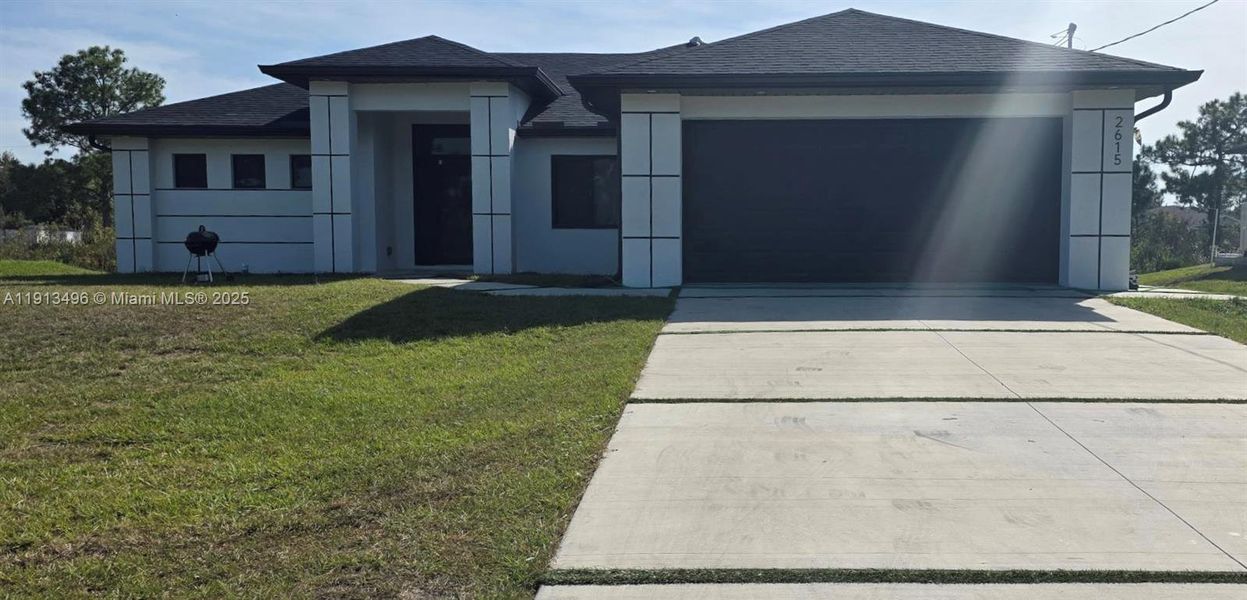 Front exterior of a new home in , Lehigh Acres, FL, highlighting curb appeal (Image 1).