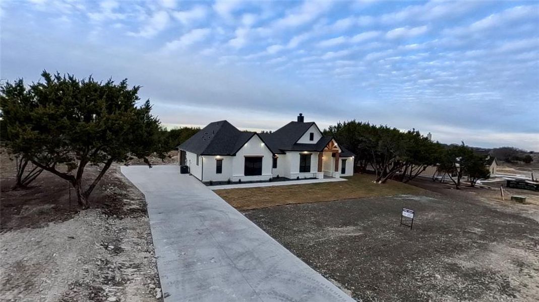 View of front of house with a chimney and a porch