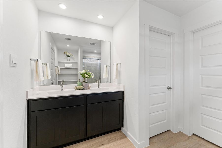 Indulge in this spa-like retreat featuring spacious double vanities that offer plenty of room for your morning and evening routines.