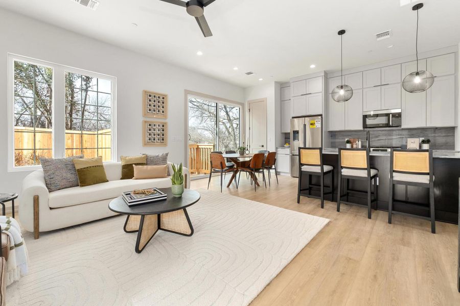 This two-story home offers 3 bedrooms, 2.5 baths, and 1,513 square feet of beautifully functional space. The main level features an open, easy-flow layout designed for everyday living and effortless hosting. The kitchen anchors the space with breakfast bar seating, stainless steel appliances including a gas range and refrigerator, and a dedicated pantry, while oversized windows flood the home with natural light. Thoughtful storage is integrated throughout, including under-stair storage, a mudroom-style nook, and a stackable washer/dryer closet with adjacent linen storage—details that make daily life feel seamless. Photo of B4- same plan staged.