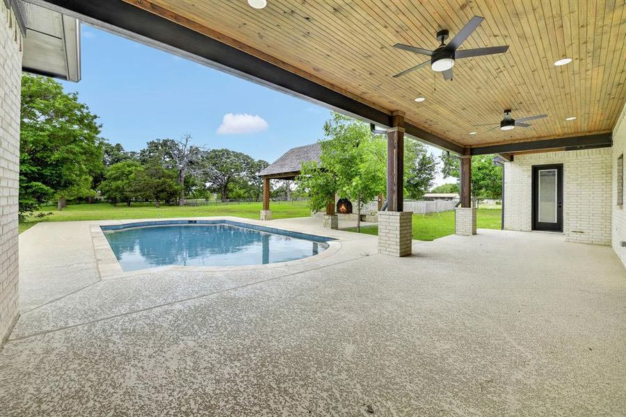 Large, oversized back patio with cedar wood cover, ceiling fans and access to indoor pool bath!