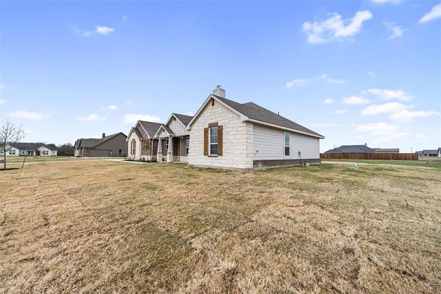 View of property exterior featuring covered porch, a chimney, and roof with shingles View of property exterior featuring covered porch, a chimney, and roof with shingles