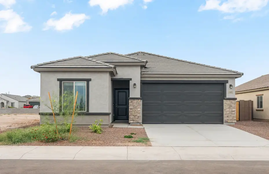 Front exterior of a new home in Copper Falls, Buckeye, AZ, highlighting curb appeal (Image 2). Front exterior of a new home in Copper Falls, Buckeye, AZ, highlighting curb appeal (Image 2).