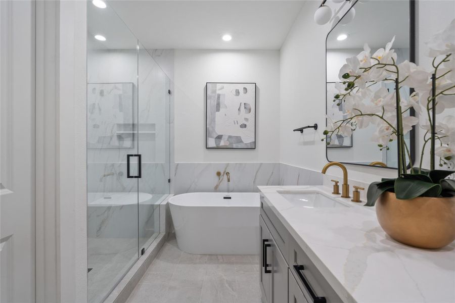 The primary ensuite mirrors the suite’s depth and elegance, creating a luxurious, spa-like retreat. Its spacious layout allows for both functionality and comfort, with thoughtfully designed details throughout. This harmonious design enhances the sense of grandeur and serenity in the primary suite.