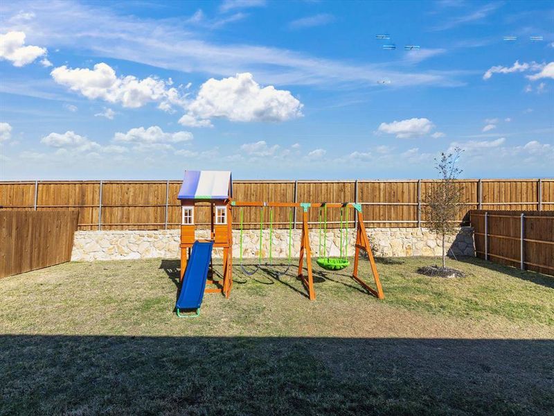 View of playground featuring a lawn