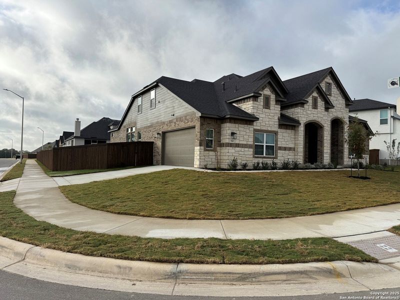 Front exterior of a new home in Mesa Western, Cibolo, TX, highlighting curb appeal (Image 2). Front exterior of a new home in Mesa Western, Cibolo, TX, highlighting curb appeal (Image 2).