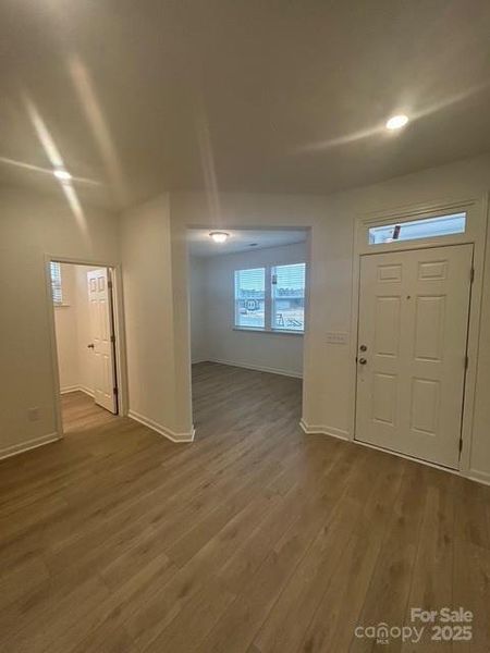 Foyer- Showcasing front door, den, and powder room.
