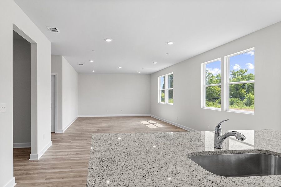 A large empty room with a sink and a large window. A large empty room with a sink and a large window.