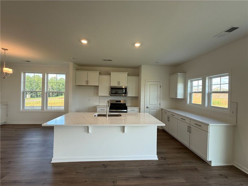 A contemporary kitchen features an inviting island A contemporary kitchen features an inviting island