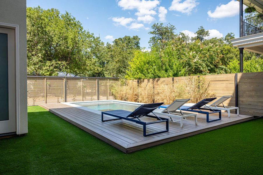 An inviting backyard oasis features a modern swimming pool surrounded by a wooden deck. An inviting backyard oasis features a modern swimming pool surrounded by a wooden deck.