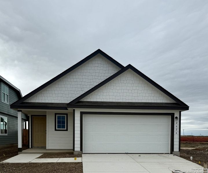 Front exterior of a new home in Dauer Ranch, New Braunfels, TX, highlighting curb appeal (Image 1).