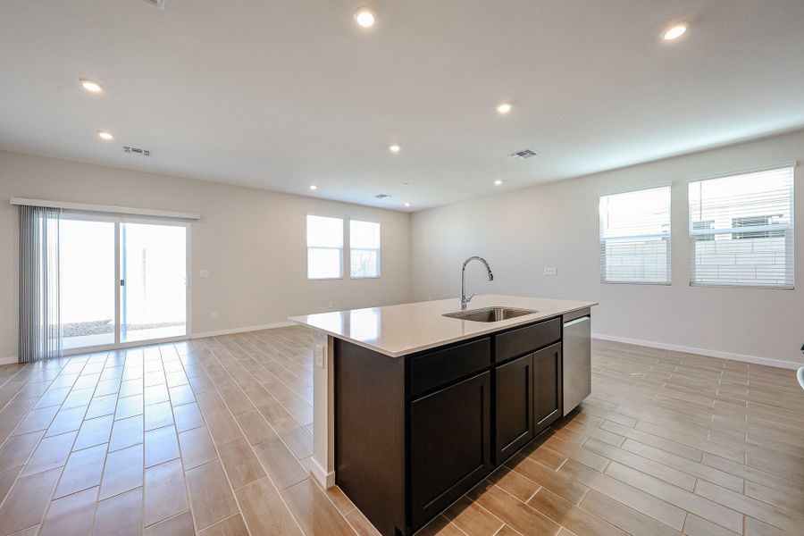 A kitchen with a wood floor. A kitchen with a wood floor.
