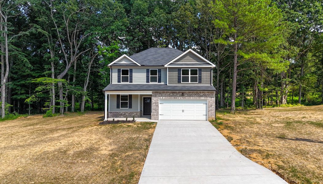 Front exterior of a new home in Woodland Farms, Dickson, TN, highlighting curb appeal (Image 2). Front exterior of a new home in Woodland Farms, Dickson, TN, highlighting curb appeal (Image 2).