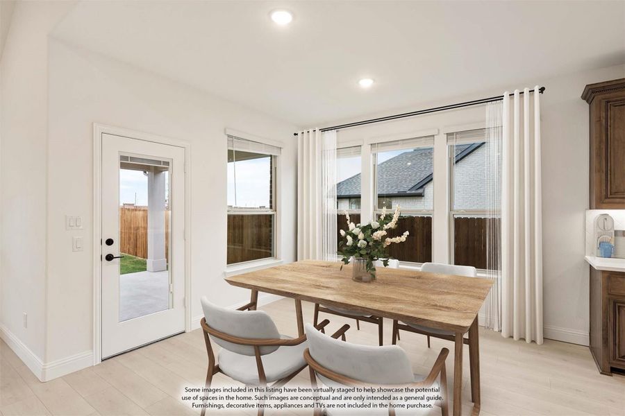 Bright dining area with wood table, white chairs, large windows, and backyard door access Bright dining area with wood table, white chairs, large windows, and backyard door access