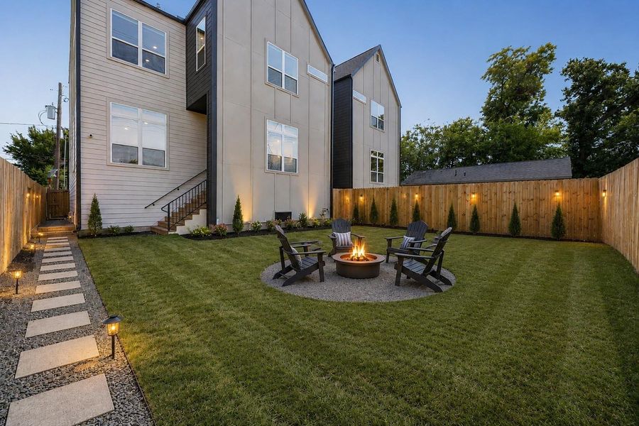 Imagine evenings spent gathered around a cozy fire pit in your own private backyard retreat. This virtually enhanced outdoor space showcases the incredible potential of the expansive yard, creating the perfect setting for relaxing with family and friends. The generous lawn still offers plenty of room for pets, play, or future outdoor additions, while the fully fenced yard provides privacy and flexibility for everyday enjoyment.