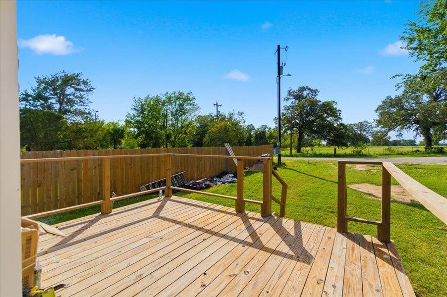 A spacious wooden deck provides ample outdoor living space. Picture sitting on your deck with your morning coffee.