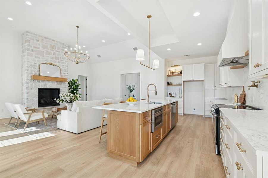 Don't miss the island-set microwave, the hutch-style appliance cabinets, the beautiful floating shelves - and of course the pot filler.