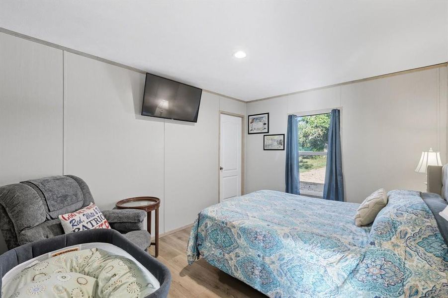 Bedroom featuring wood finished floors and recessed lighting Bedroom featuring wood finished floors and recessed lighting