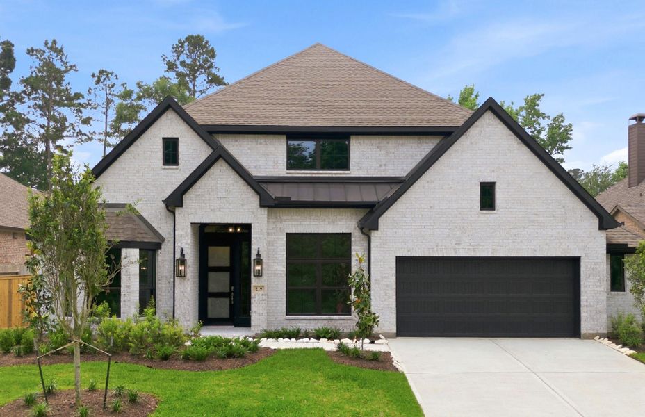Front exterior of a new home in The Woodlands Hills 65′, Willis, TX, highlighting curb appeal (Image 1). Front exterior of a new home in The Woodlands Hills 65′, Willis, TX, highlighting curb appeal (Image 1).