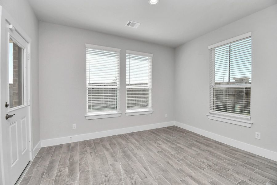 Enjoy breakfast with ease in the connected and cozy breakfast area, seamlessly integrated with the kitchen for utmost convenience. Step through the back door for a breath of fresh air onto the covered patio, extending your living space to the outdoors. Sample photo of completed home with similar floor plan. Actual colors and selections may vary.