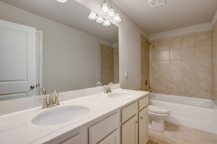 Double vanitiy sinks located in the bathroom on the second level