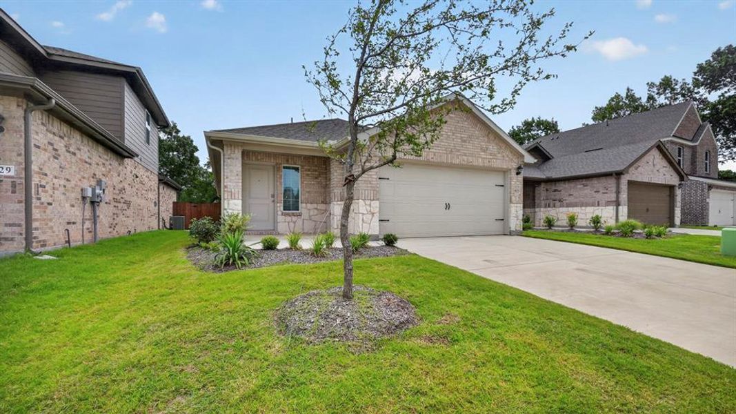 Front exterior of a new home in Hanolley Hills, Sherman, TX, highlighting curb appeal (Image 6). Front exterior of a new home in Hanolley Hills, Sherman, TX, highlighting curb appeal (Image 6).