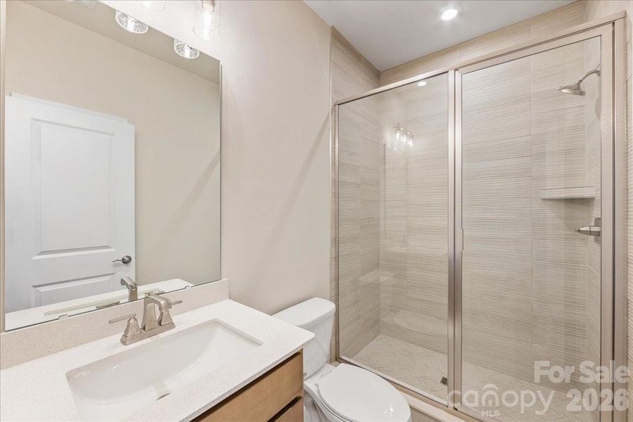 First Floor Full Bath with Tile Surround Walk-In Shower.