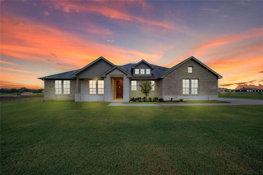 View of front of house with a lawn, stone siding, and a shingled roof View of front of house with a lawn, stone siding, and a shingled roof