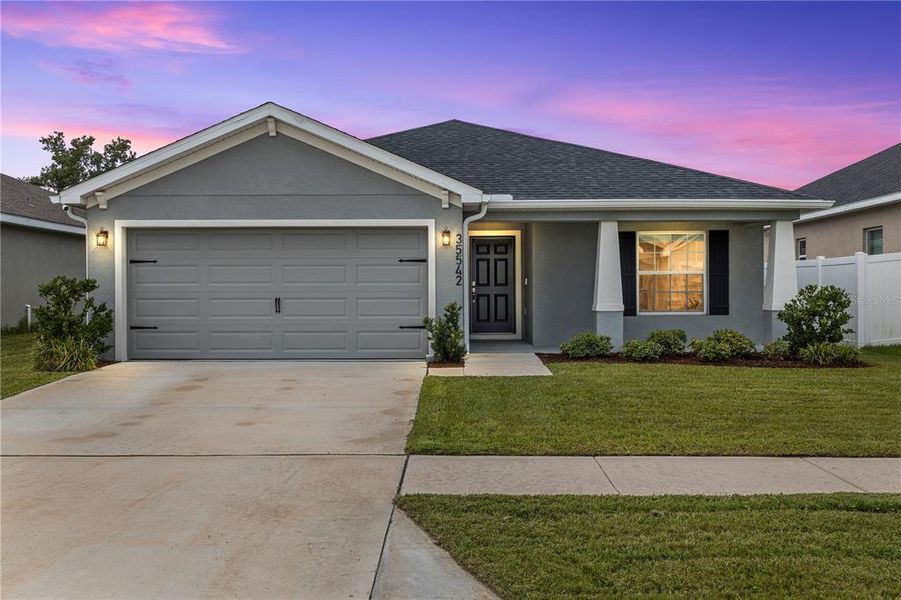 Front exterior of a new home in Stonebridge North, Zephyrhills, FL, highlighting curb appeal (Image 21). Front exterior of a new home in Stonebridge North, Zephyrhills, FL, highlighting curb appeal (Image 21).