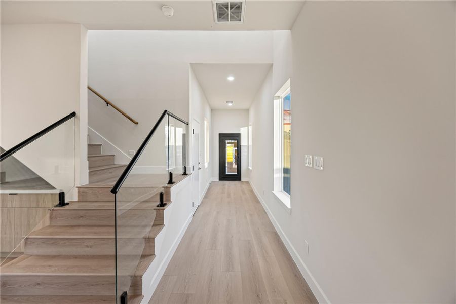 Staircase featuring wood finished floors and recessed lighting.
