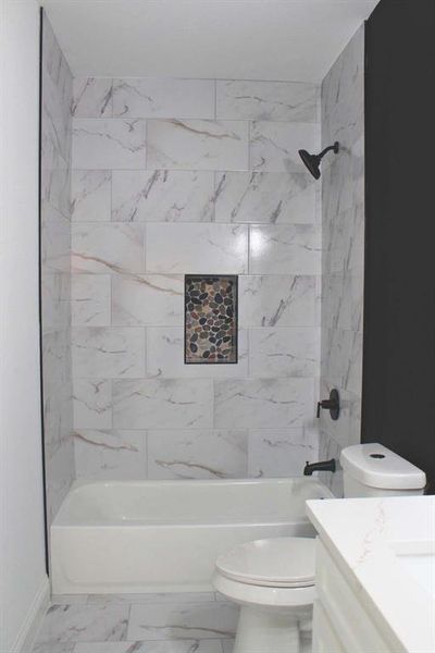 Bathroom with vanity, marble finish floors, and shower / washtub combination Bathroom with vanity, marble finish floors, and shower / washtub combination