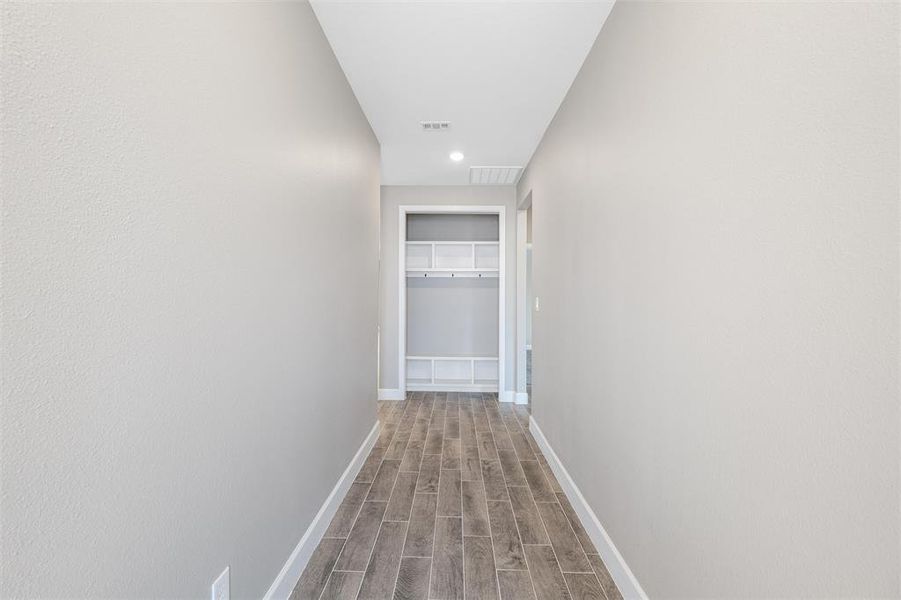 Corridor featuring wood-type flooring