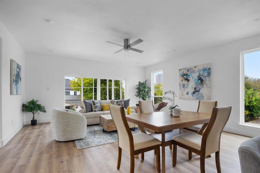 Dining space featuring ceiling fan, a healthy amount of sunlight, and light hardwood / wood-style floors